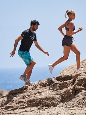 models wearing arena sportswear collection runnign up a hill beautiful scenic background