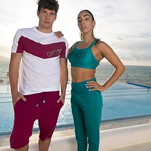 models wearing arena sporstwear t-shirts shorts sports bras leggings in a beautiful beach setting