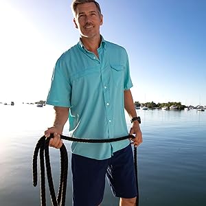 Men wearing blue huk tide point button down short sleeve while fishing