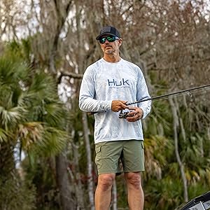 Men wears huk creekbed shorts while fishing