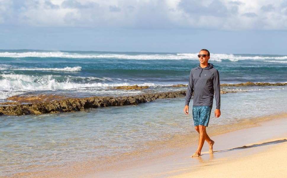 Man walking on the beach wearing o''neill hybrid sun shirt hoodie